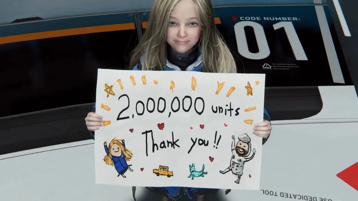 Diana holding up a drawing saying 2,000,000 units sold, Thank you!