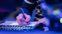 someone writing down in a notebook