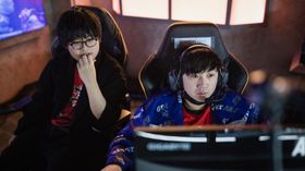 Two players of SAG looking into monitor while drafting