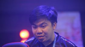 Sam_H of Omega Esports smiling at the monitor