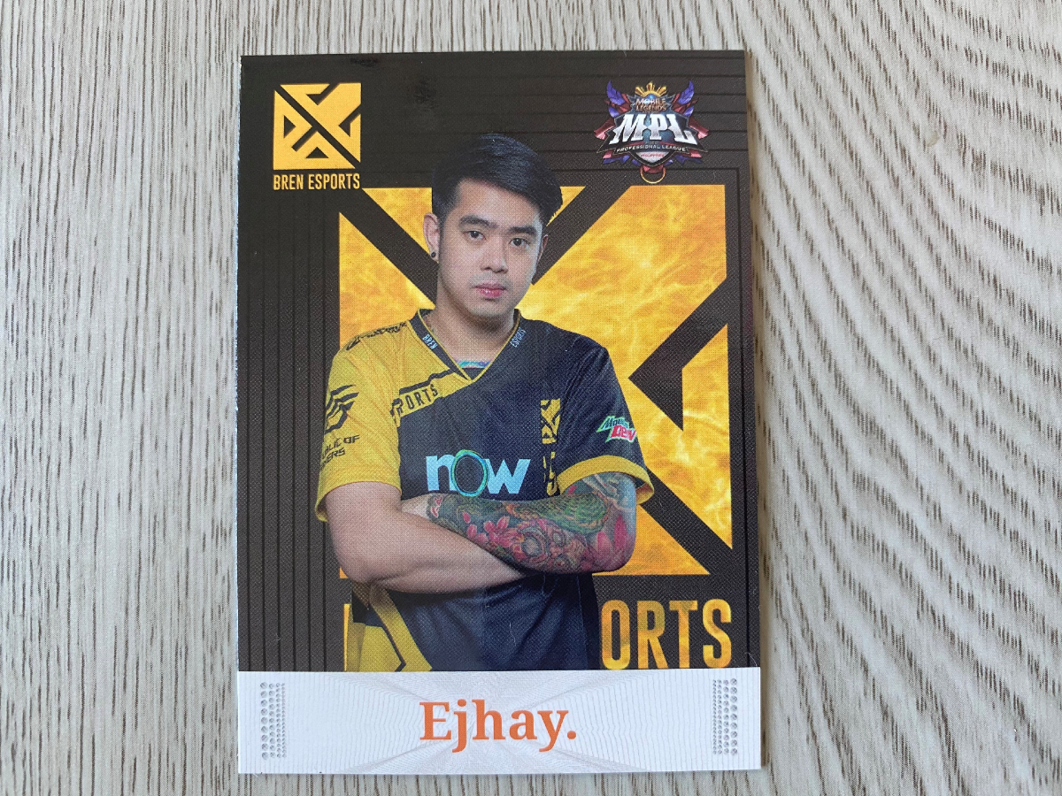 Ejhay standing with arms crossed Player card