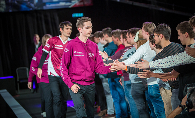 image shows ROCCAT's new signup high-fiving fans at EU LCS Spring Split 2016 with previous team, Unicorns of Love
