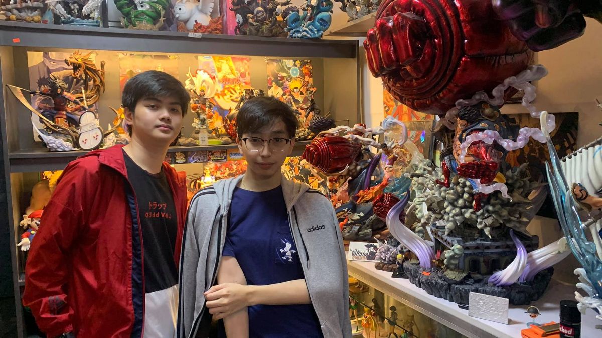 OhMyV33nus and Wise standing in store surrounding by action figurines