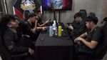 Execration MLBB team sitting around a table post game