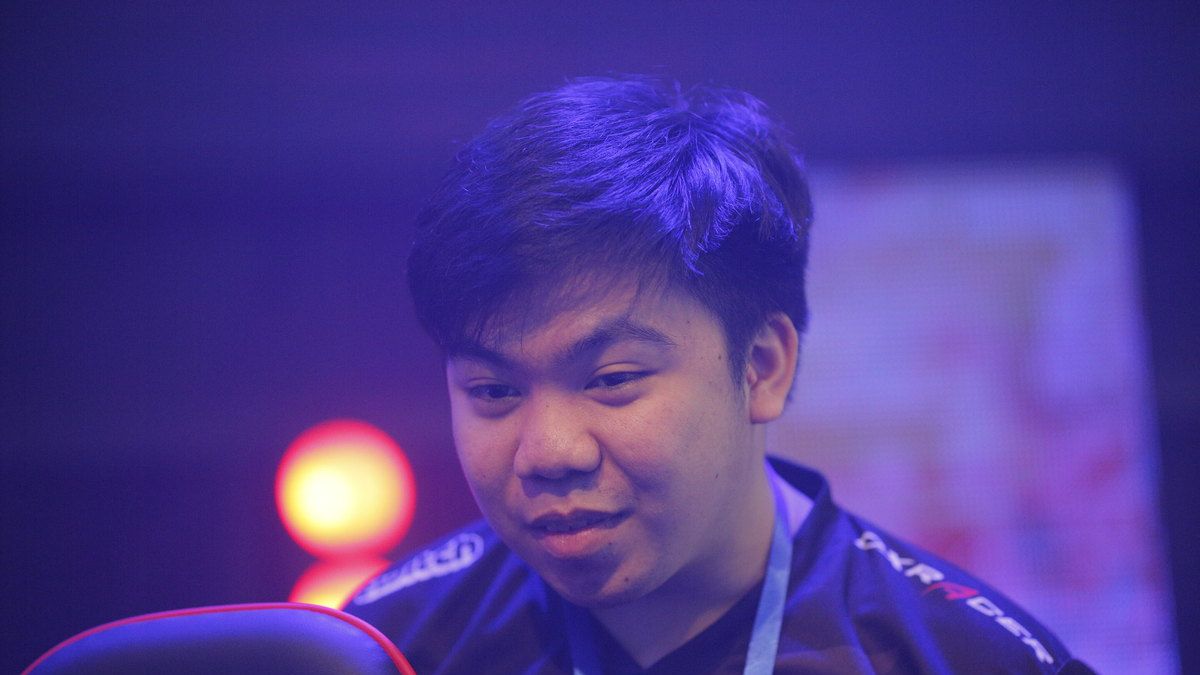 Sam_H of Omega Esports smiling at the monitor